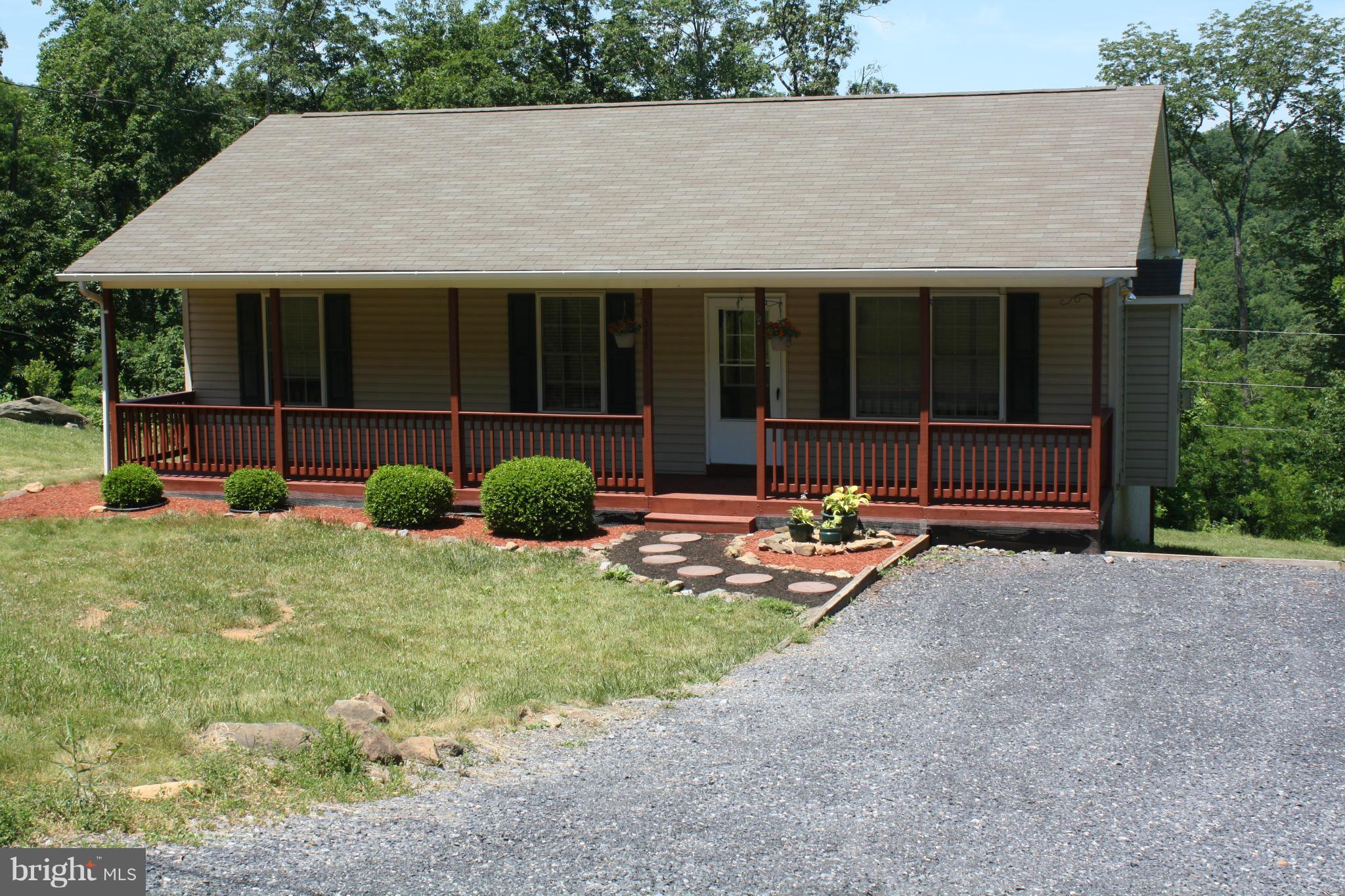 345 Mcdonalds Farm Road Linden, VA 22642 - Photo 1 of 29 a view of a house with backyard and sitting area