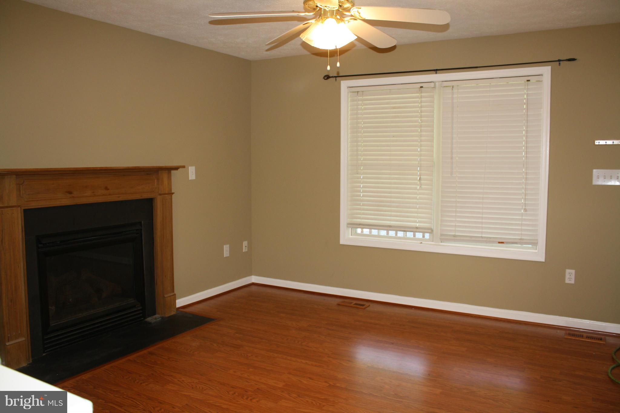 345 Mcdonalds Farm Road Linden, VA 22642 - Photo 15 of 29 a view of an empty room with wooden floor fireplace and a window