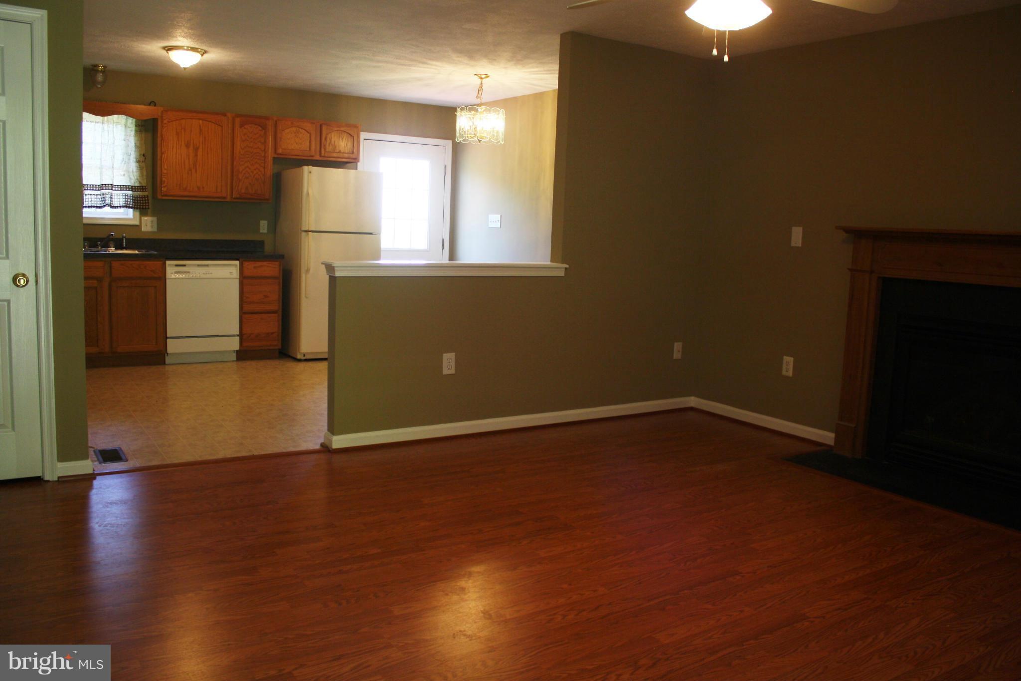 345 Mcdonalds Farm Road Linden, VA 22642 - Photo 16 of 29 a view of a kitchen with a fridge and wooden floor