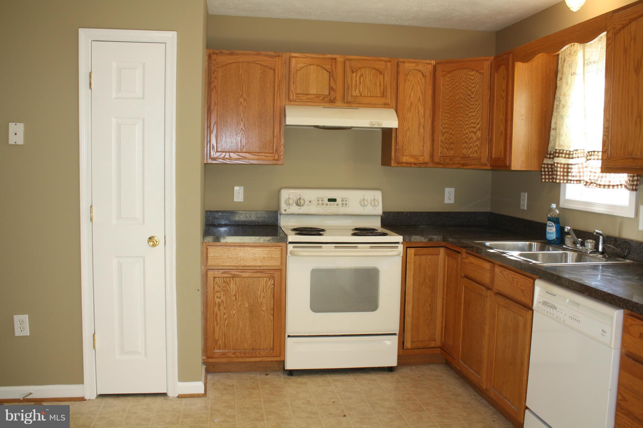 345 Mcdonalds Farm Road Linden, VA 22642 - Photo 17 of 29 a kitchen with a stove sink and cabinets