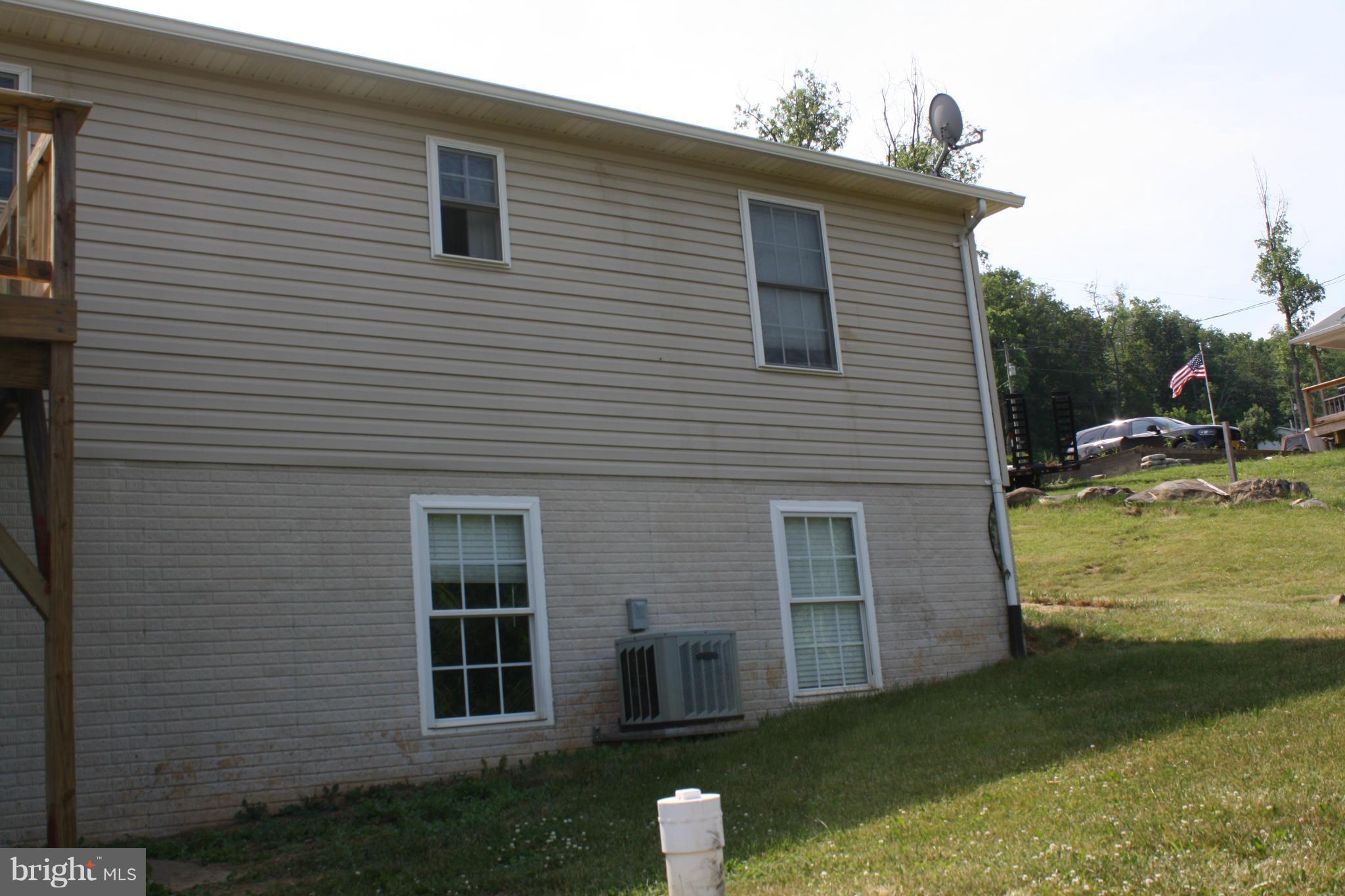345 Mcdonalds Farm Road Linden, VA 22642 - Photo 5 of 29 a front view of a house with a garden and yard