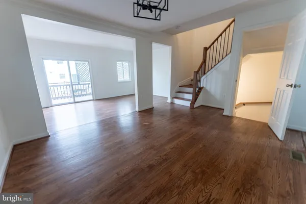 a view of an entryway with wooden floor