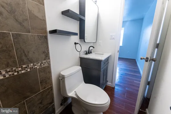 a white toilet sitting next to a bathroom sink