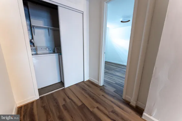 a view of walk in closet with wooden floor