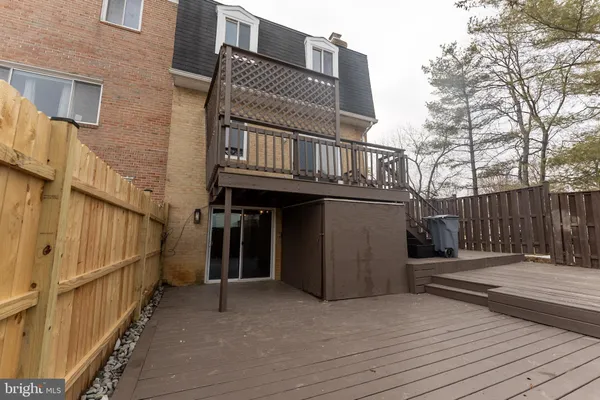 a view of a house with wooden fence