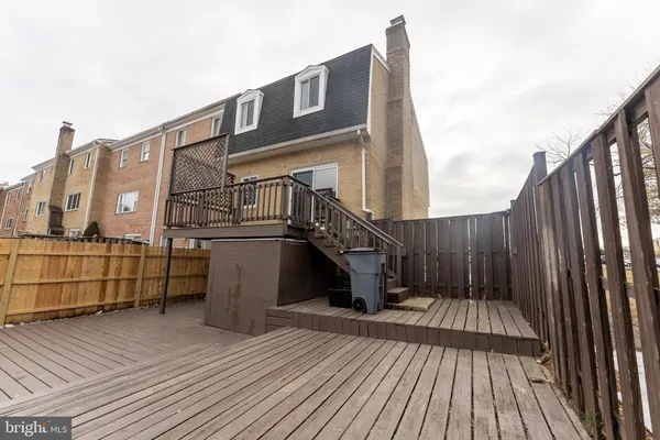 a view of balcony with wooden floor and fence