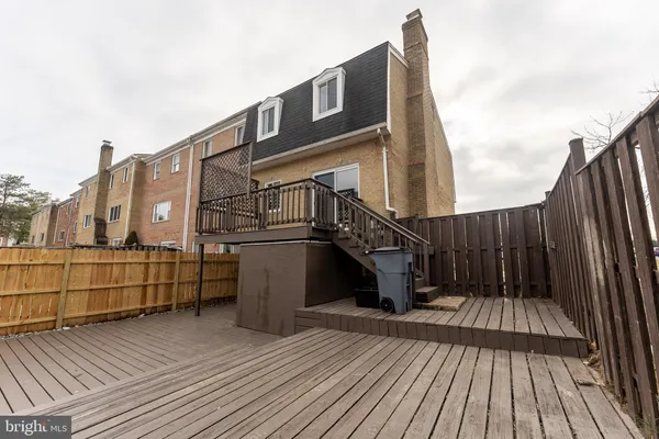 a view of a balcony with wooden floor and fence