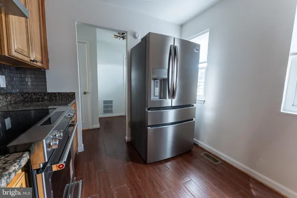 a kitchen with stainless steel appliances granite countertop a refrigerator microwave and stove