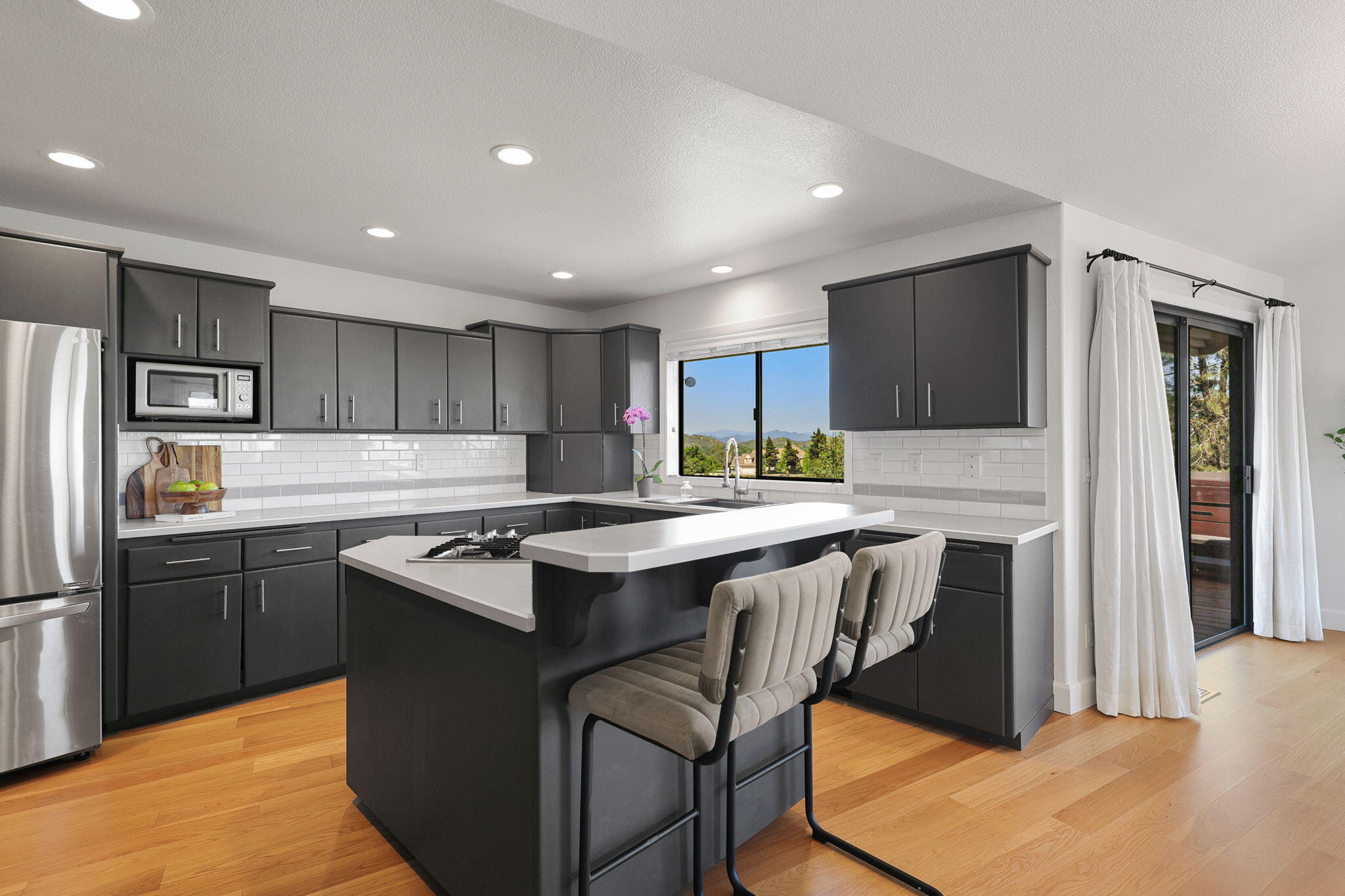 8454 Crown Way Redding, CA 96001 - Photo 8 of 44 a kitchen with kitchen island granite countertop a sink counter top space stainless steel appliances and cabinets
