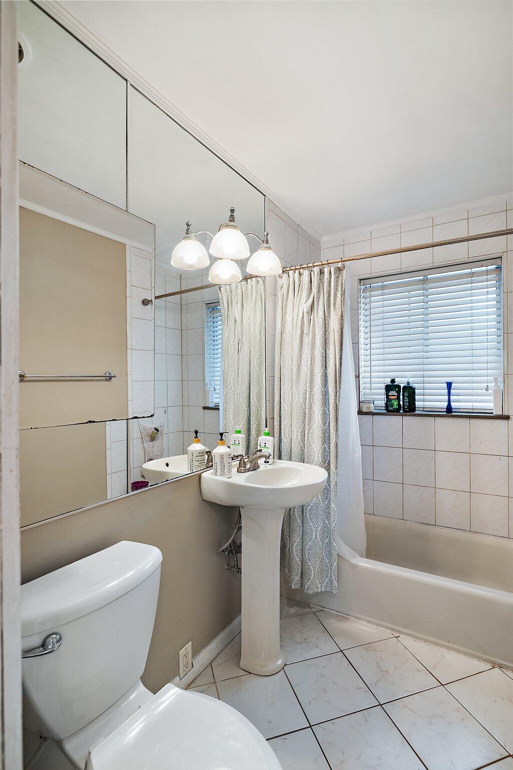 216 Southmoor Road Hammond, IN 46324 - Photo 14 of 19 a bathroom with a sink a toilet and shower