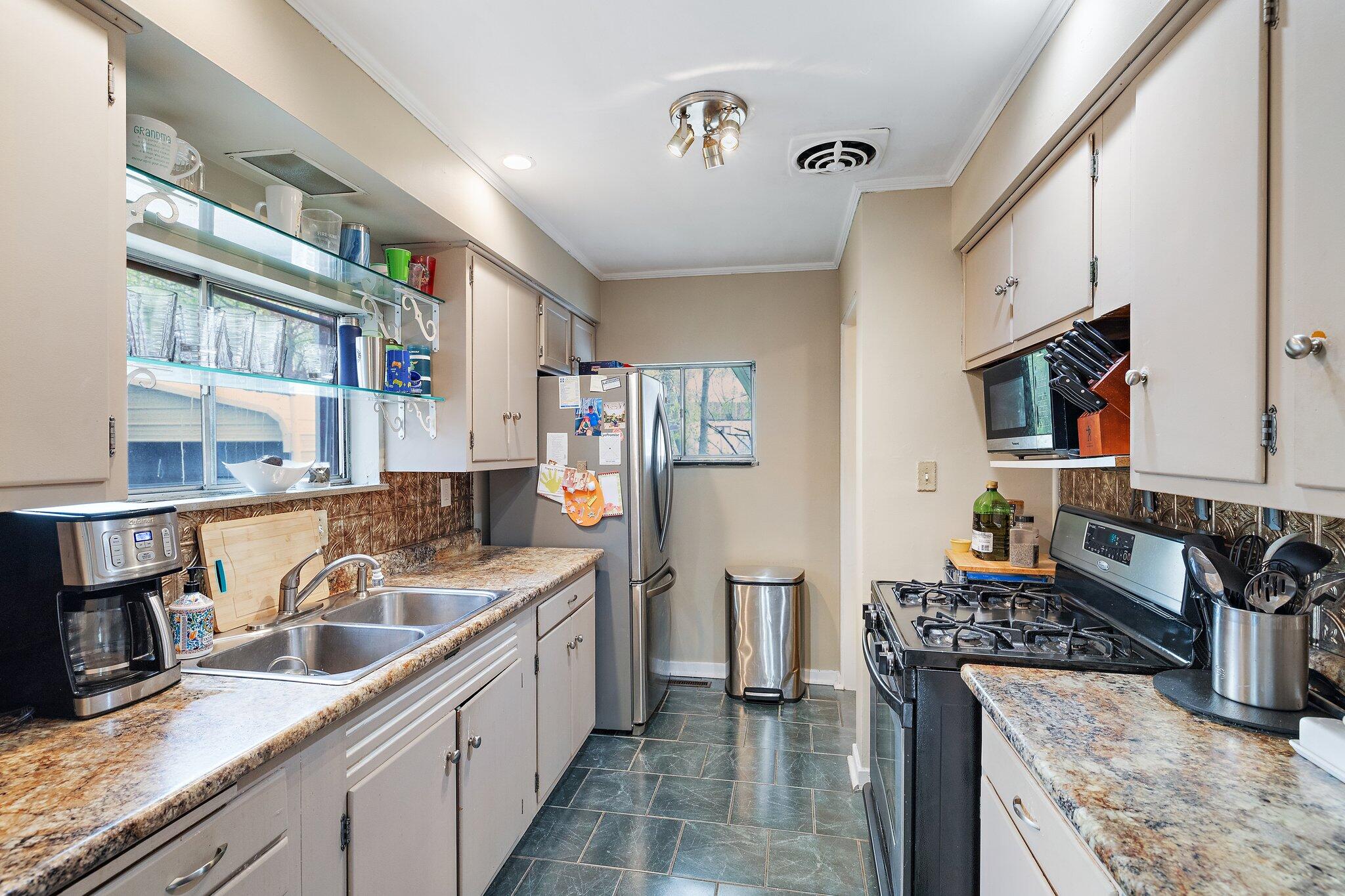 216 Southmoor Road Hammond, IN 46324 - Photo 5 of 19 a kitchen with stainless steel appliances granite countertop a sink and a stove