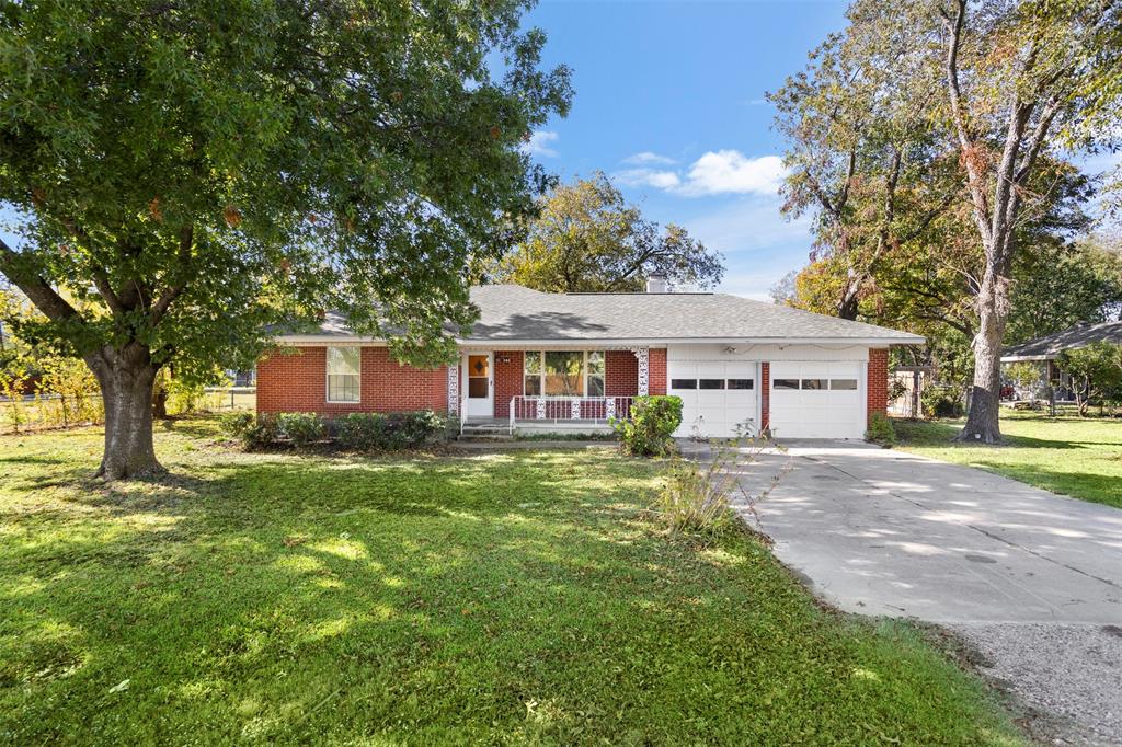203 Main Street Red Oak, TX 75154 - Photo 1 of 32 a view of a yard in front of a house with large tree