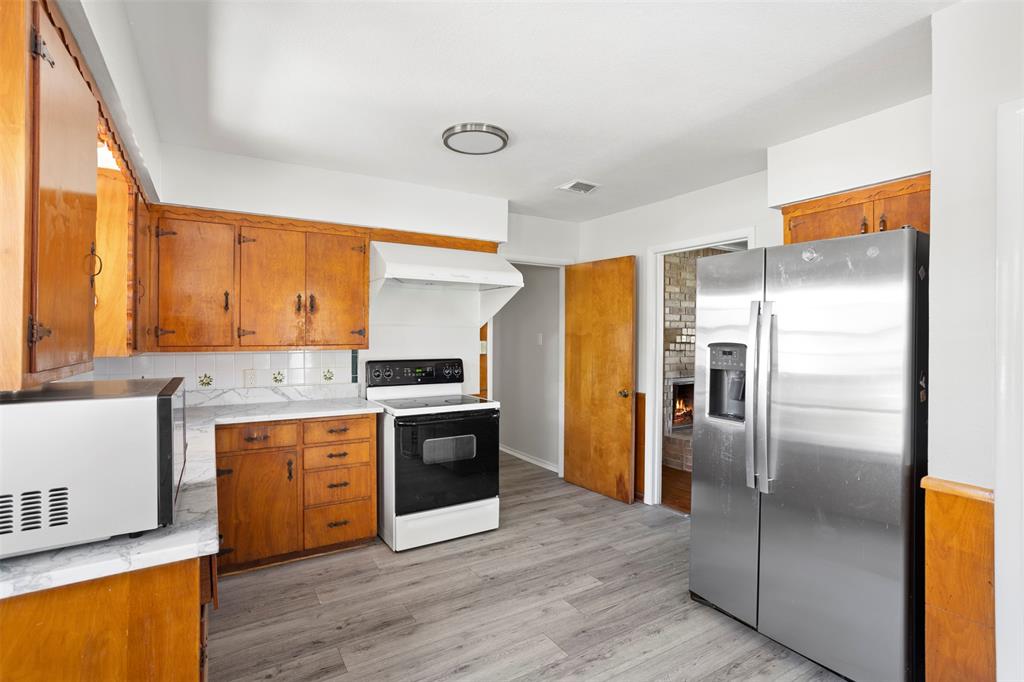 203 Main Street Red Oak, TX 75154 - Photo 12 of 32 a kitchen with stainless steel appliances granite countertop a refrigerator a sink and a stove