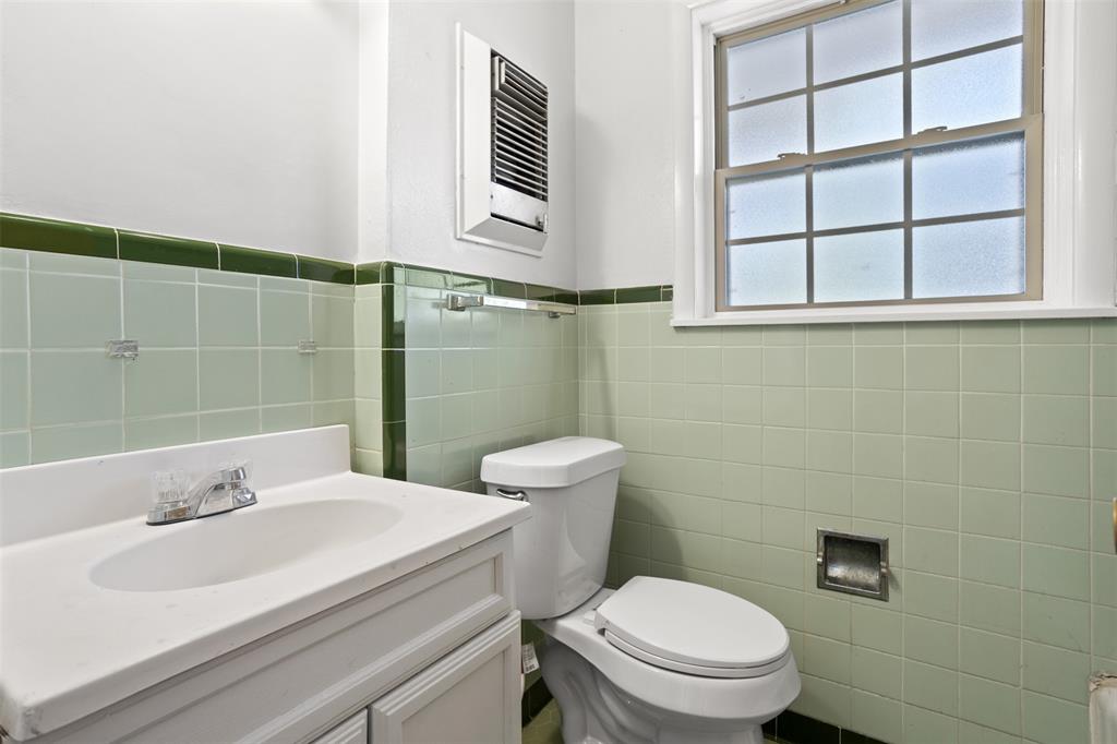 203 Main Street Red Oak, TX 75154 - Photo 15 of 32 a bathroom with a sink a toilet and a mirror