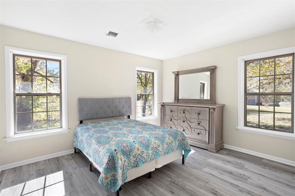 203 Main Street Red Oak, TX 75154 - Photo 16 of 32 a bedroom with a large bed and a window