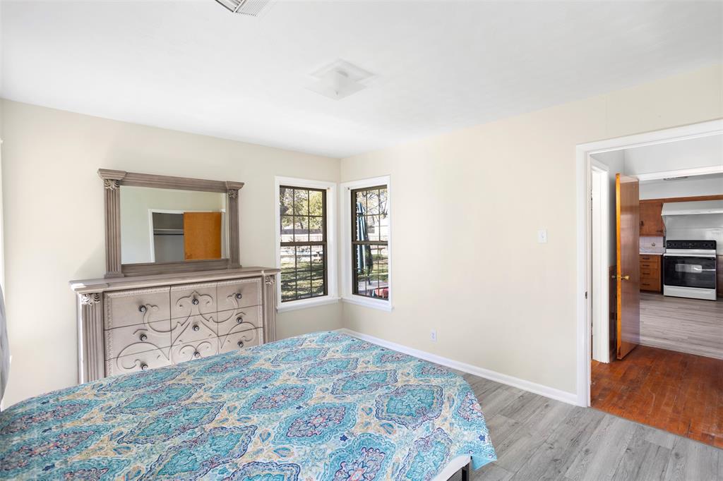 203 Main Street Red Oak, TX 75154 - Photo 17 of 32 a bedroom with a bed and a dresser