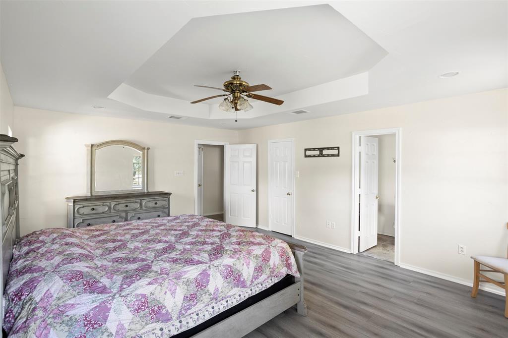 203 Main Street Red Oak, TX 75154 - Photo 21 of 32 a bedroom with a bed and a ceiling fan