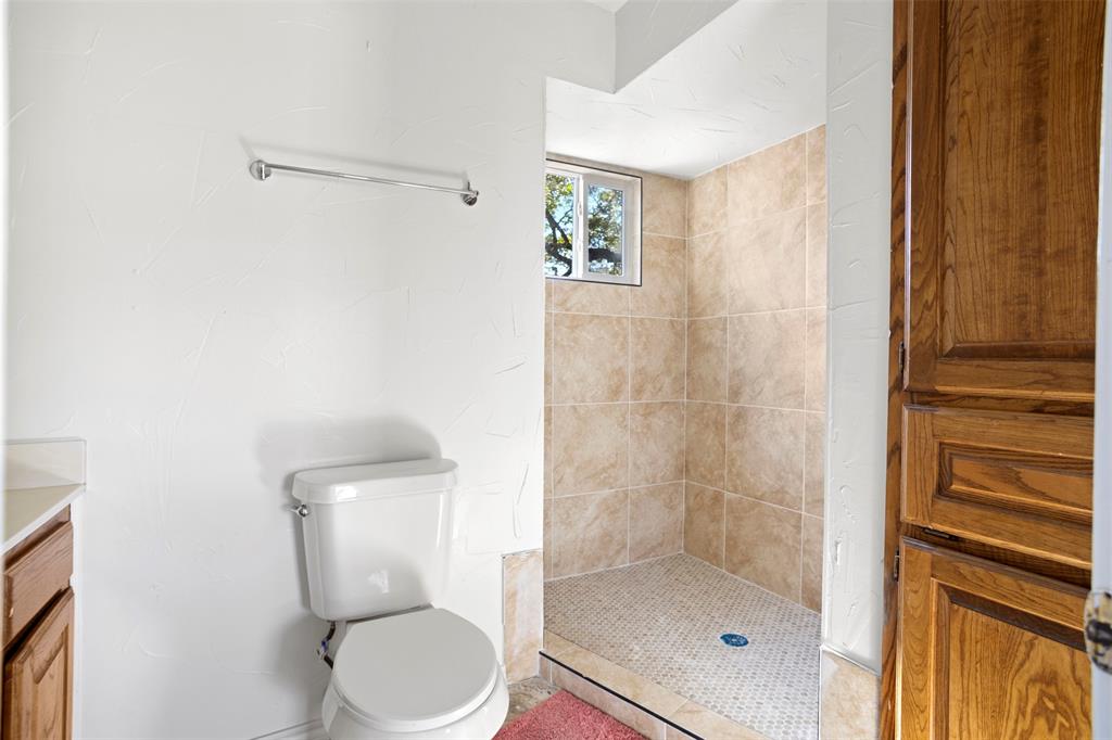 203 Main Street Red Oak, TX 75154 - Photo 22 of 32 a white toilet sitting next to a bathroom sink