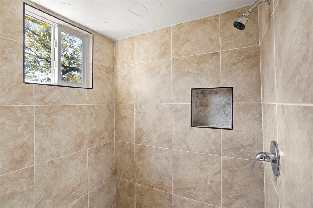 203 Main Street Red Oak, TX 75154 - Photo 24 of 32 a bathroom with a window and a shower