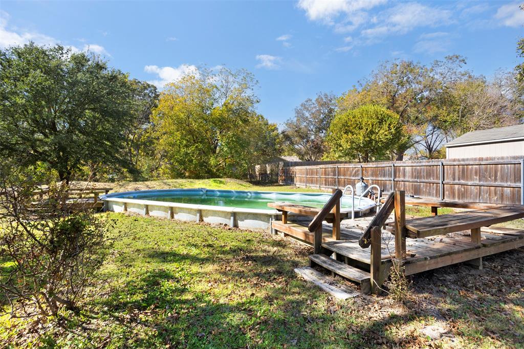203 Main Street Red Oak, TX 75154 - Photo 27 of 32 a view of a lake with a bench and trees around