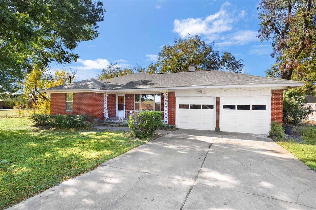 203 Main Street Red Oak, TX 75154 - Photo 4 of 32 a front view of a house with a garden and trees