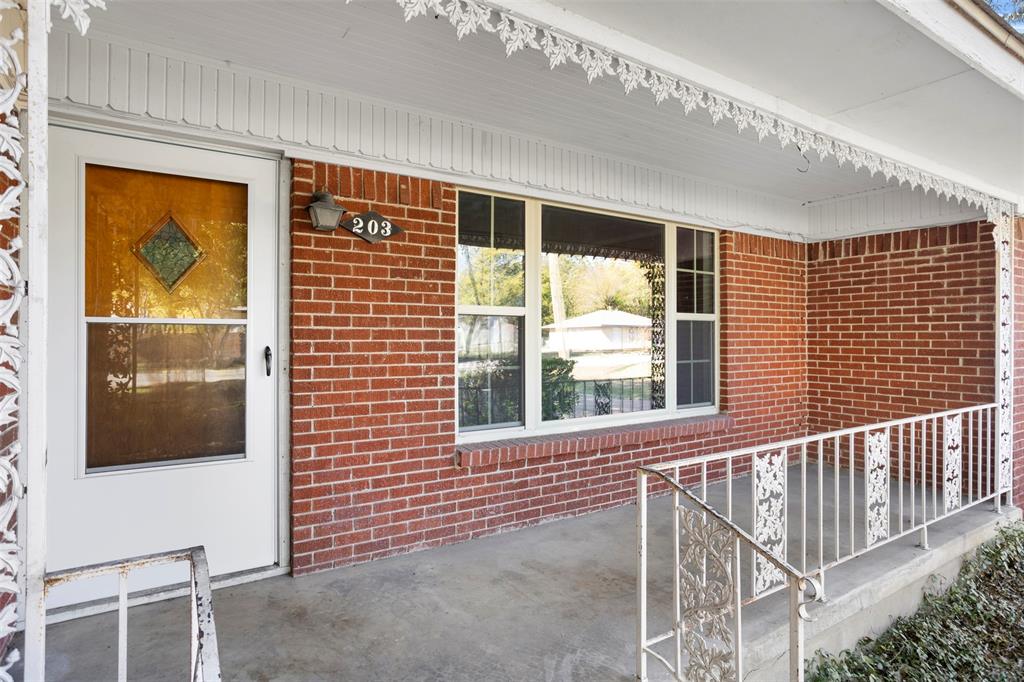 203 Main Street Red Oak, TX 75154 - Photo 5 of 32 a view of a porch with a table and chairs