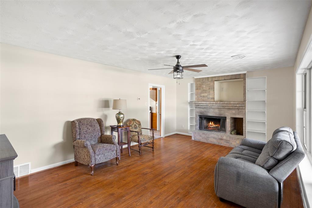 203 Main Street Red Oak, TX 75154 - Photo 6 of 32 a living room with furniture and a fireplace