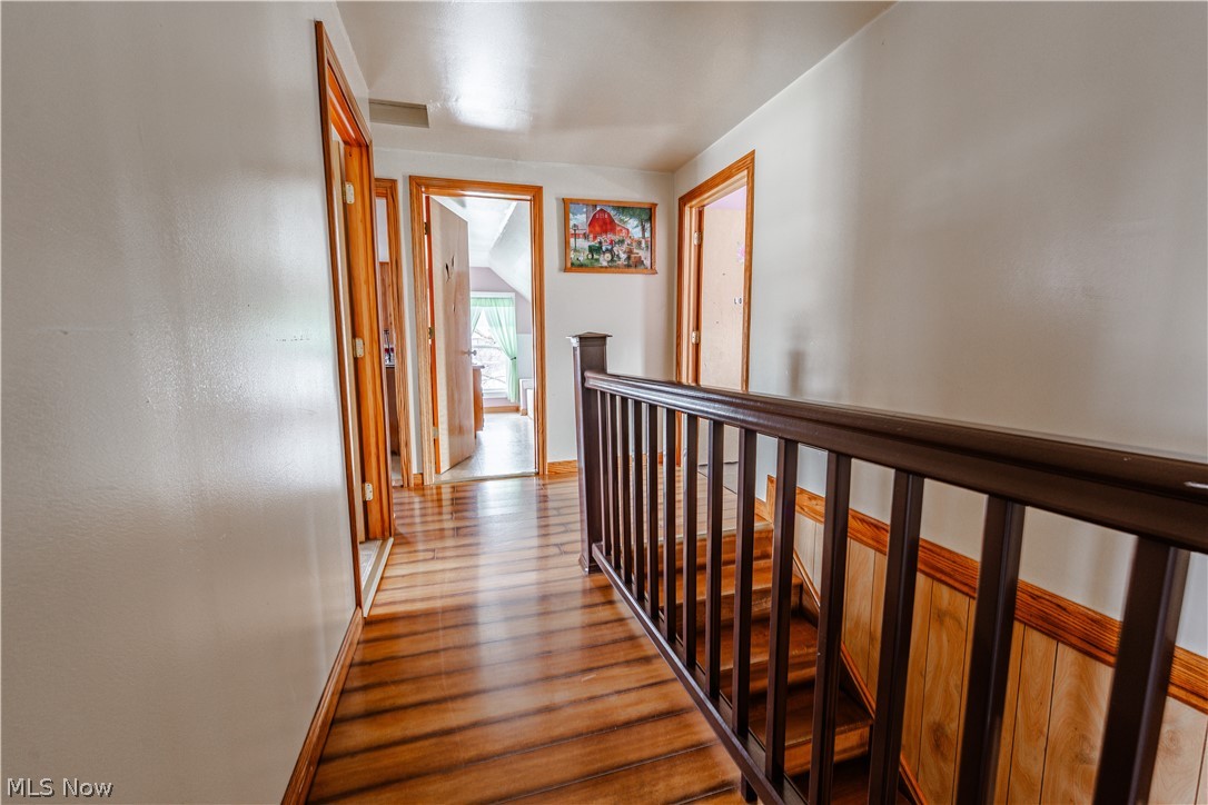 16350 Nauvoo Road Middlefield, OH 44062 - Photo 38 of 50 Hall with wood finished floors and an upstairs landing