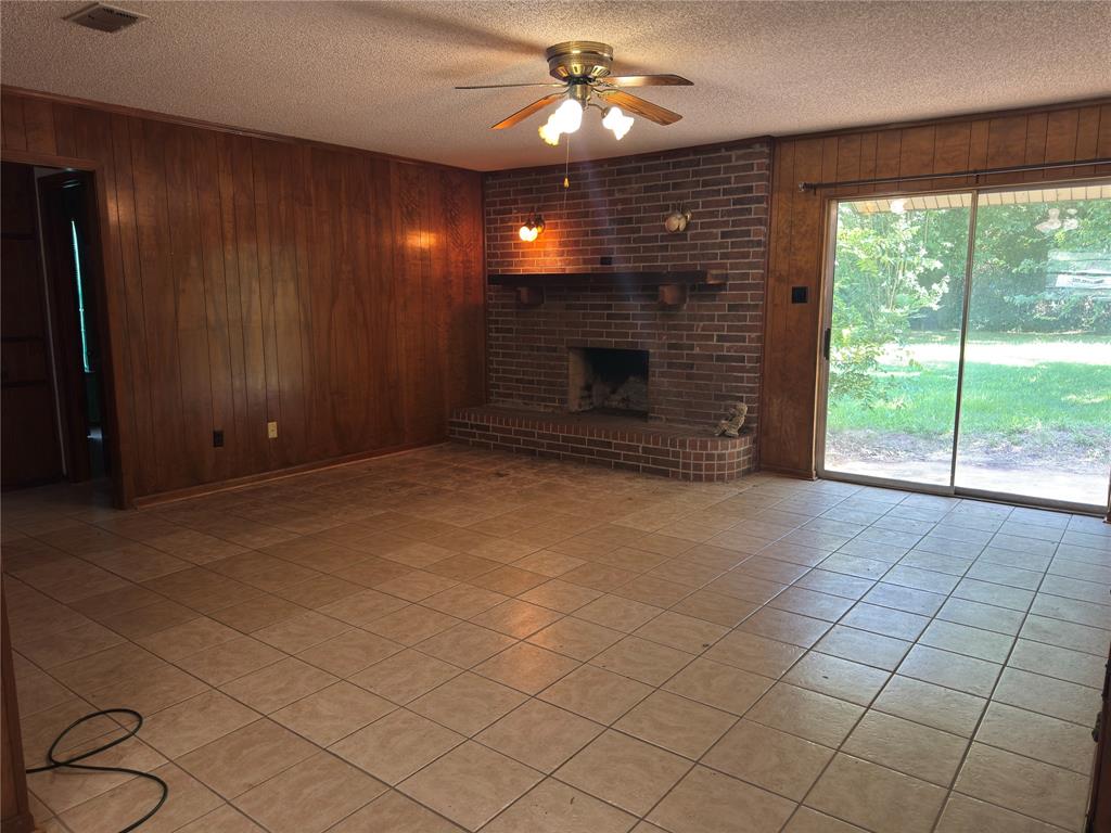 415 Meadowlark Trail Springtown, TX 76082 - Photo 9 of 40 a view of an empty room with a fireplace
