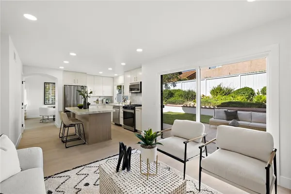 a living room with furniture dining area and a large window