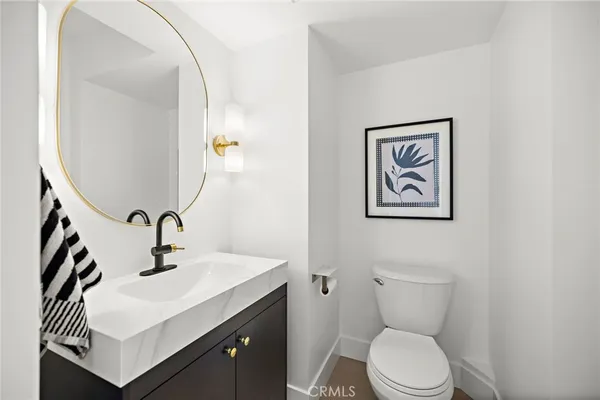 a bathroom with a sink mirror and toilet