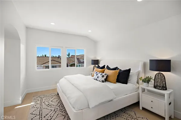 a bedroom with a large bed and a window