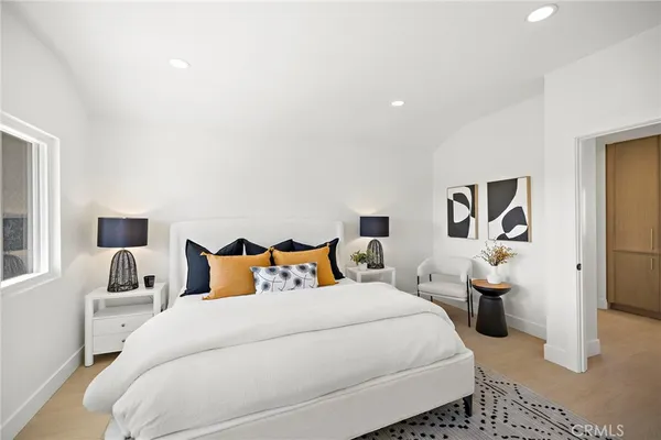 a bedroom with bed and wooden floor
