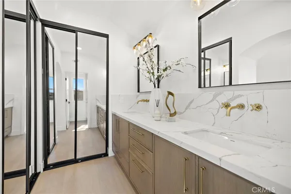a bathroom with a double vanity sink mirror and shower