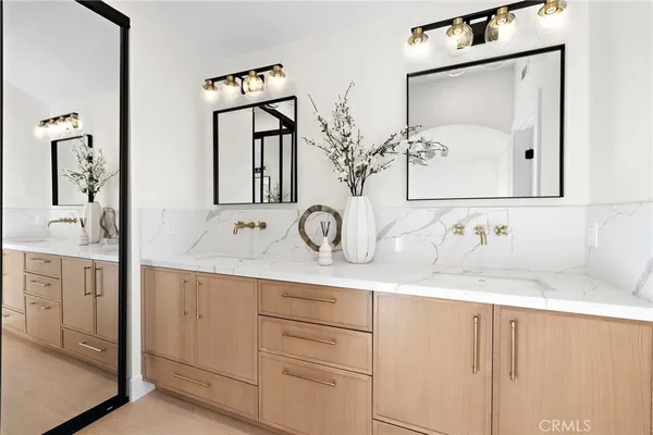 a bathroom with a double vanity sink and a mirror