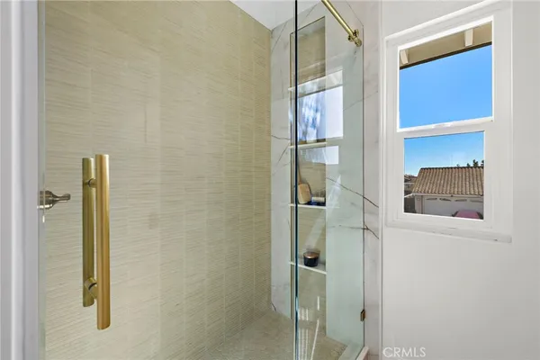 a bathroom with a shower and a glass door