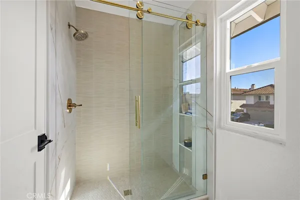 a bathroom with a glass shower door