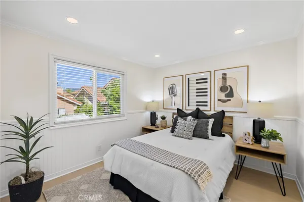 a bedroom with a large bed and a window
