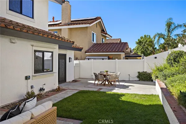 a view of house and yard with patio