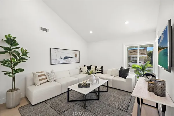 a living room with furniture and a potted plant