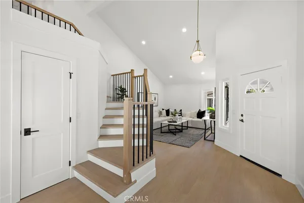 a view of a livingroom with a hall and kitchen view