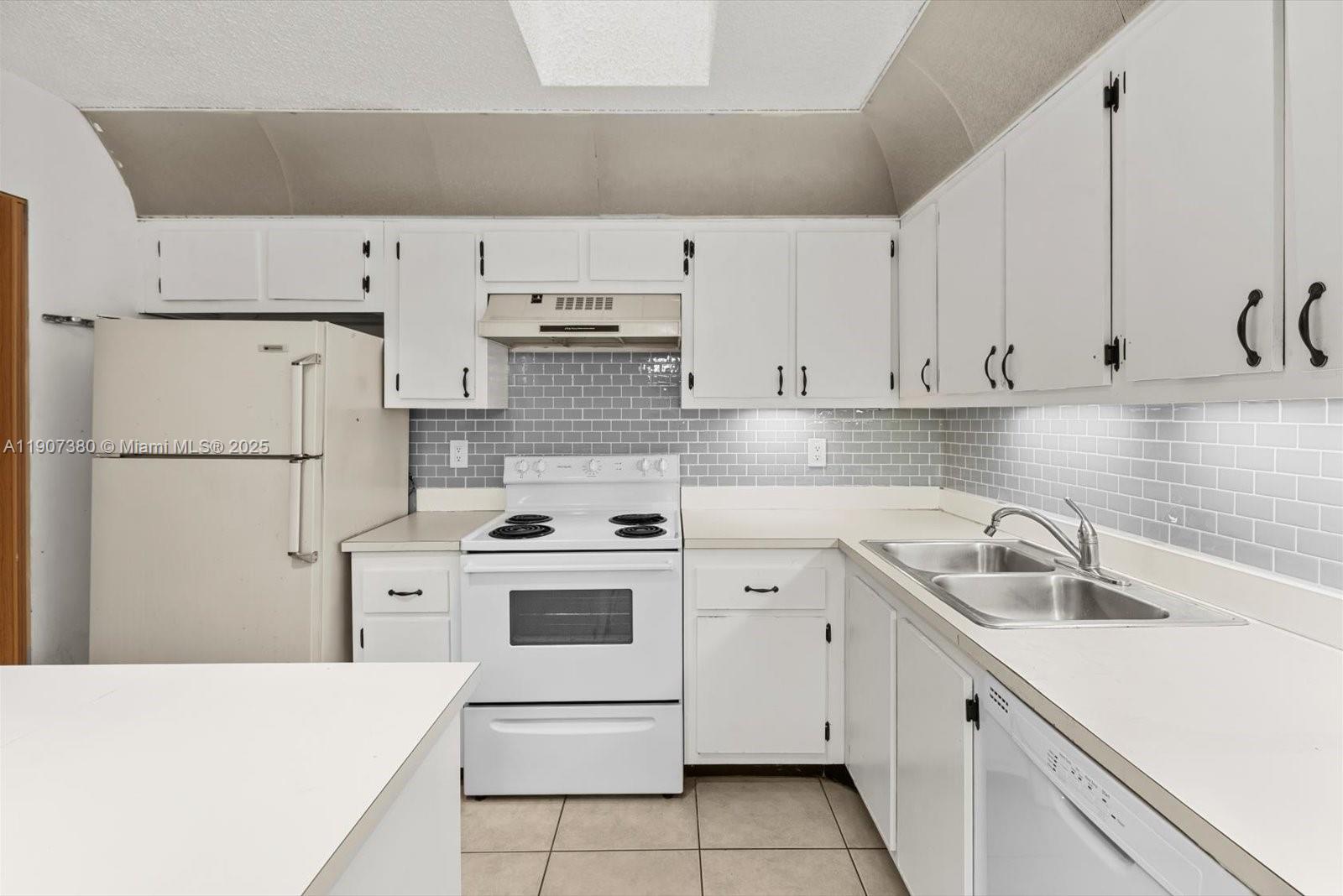 3502 Waterview Circle Palm Springs, FL 33461 - Photo 13 of 39 a kitchen with a sink a stove and refrigerator