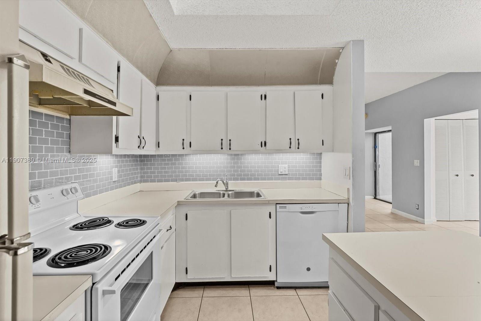 3502 Waterview Circle Palm Springs, FL 33461 - Photo 16 of 39 a kitchen with cabinets appliances a sink and a stove