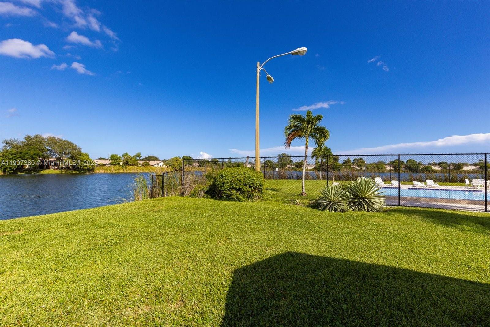 3502 Waterview Circle Palm Springs, FL 33461 - Photo 36 of 39 a view of a lake with a house in the background
