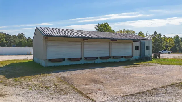 a view of backyard of house with green space