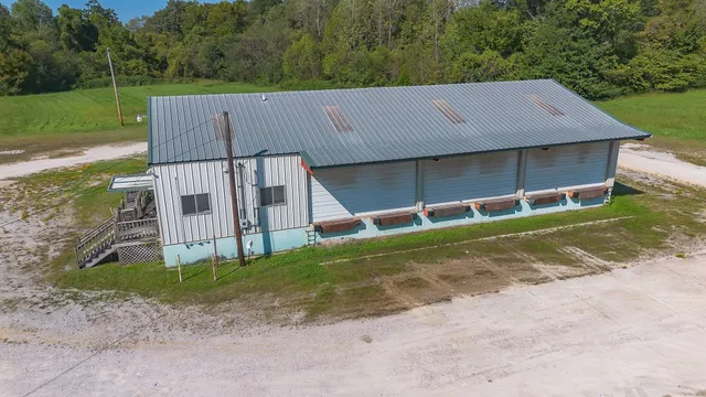 a view of a house with a yard and a fence