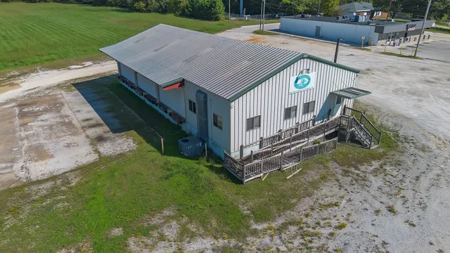 a aerial view of a house with a yard and sitting area
