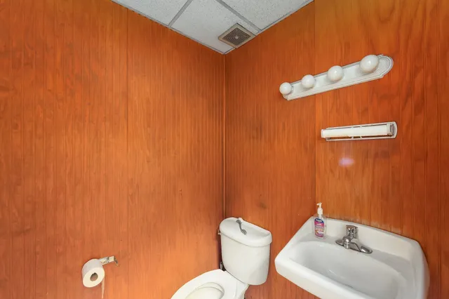 a bathroom with a toilet sink and mirror