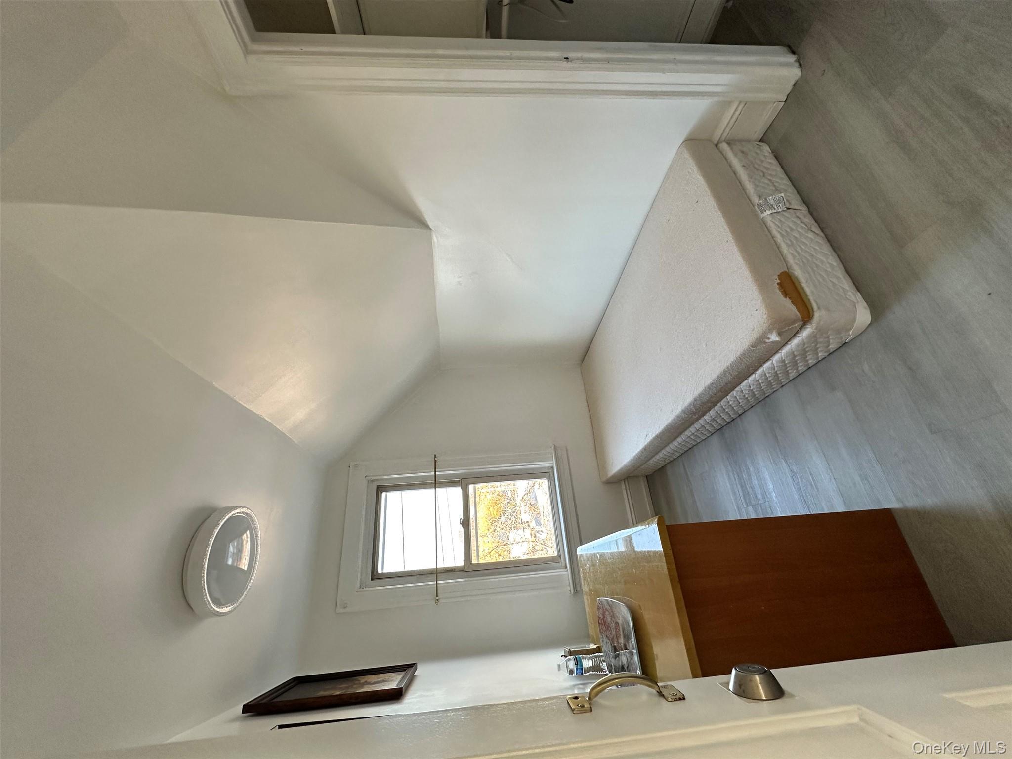 77-02 164th Street, Unit 3 Queens, NY 11366 - Photo 11 of 16 a spacious bedroom with a bed and a dresser next to a window