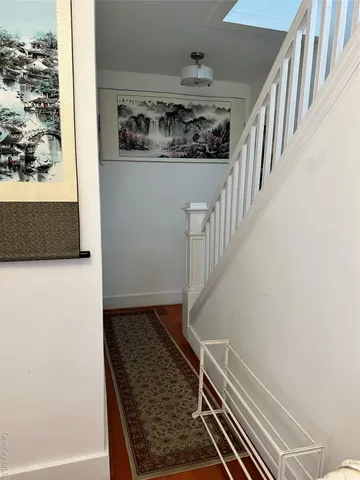 a view of a hallway to a livingroom and a couch